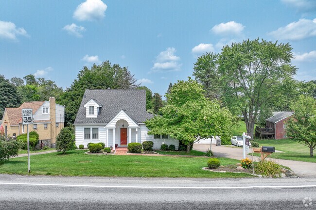 A cozy cottage with a well-manicured lawn can be found in Economy.