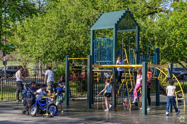 As the temperature rises, kids enjoy the fountain and playground in Clove Lakes Park.