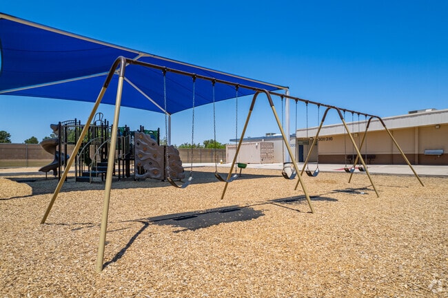Children have fun on the swings at Richard E Miller School in Phoenix.