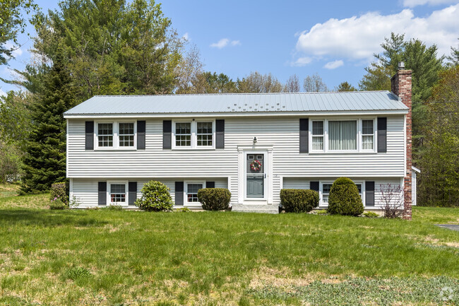 Photo of a raised ranch style home in Casco, Maine.