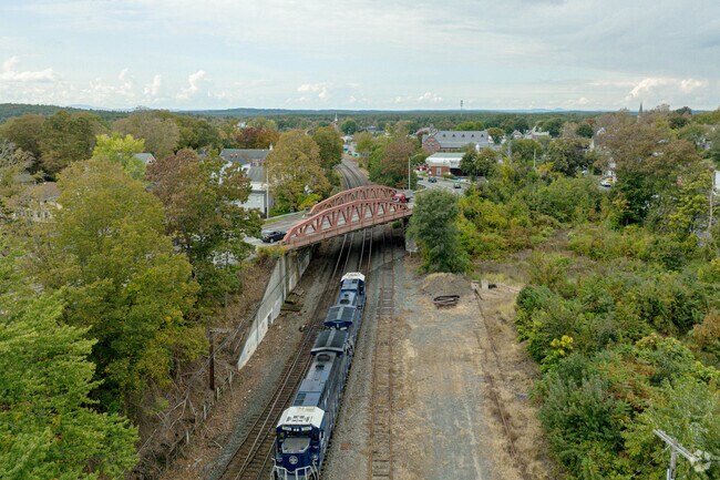 A locomotive passes under the Main Street bridge, minutes from the Ayer commuter rail station.