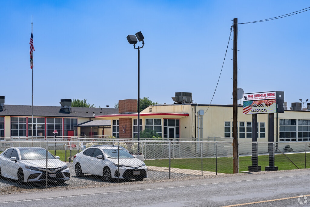 An American flag waves in front of Pond Elementary School in McFarland.