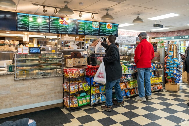 A man picks up his order at Moulton's Kitchen & Market in Amherst.