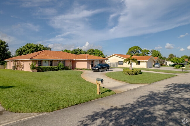 A row of ranch-style homes lines a street in Lake Clarke Shores, Florida.
