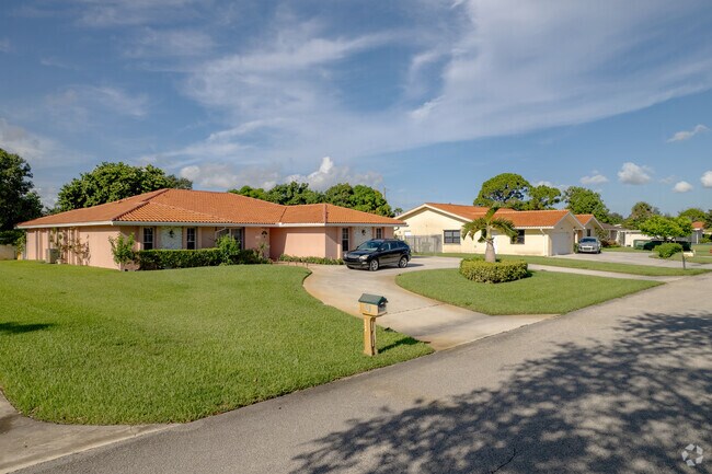 A row of Ranch style homes adorns this street in Lake Clarke Shores, FL.