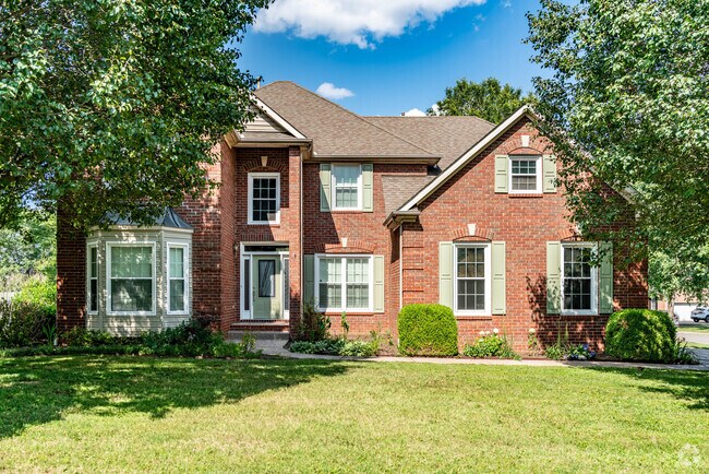 Traditional brick homes in Traceside feature shaded front lawns.