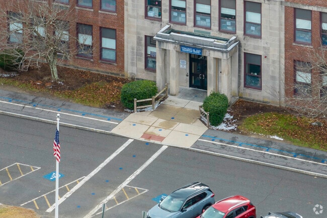 Aerial views reveal Vincent M. Igo Elementary School's modern design and green spaces.