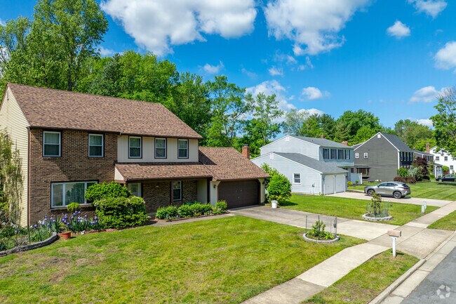 Colonial revival homes in Greentree offer private parking with driveways and garages.