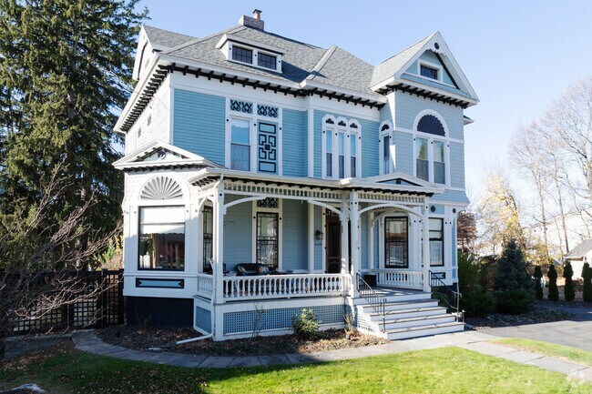 A beautiful Victorian home with a lovely porch in Troy, NY.