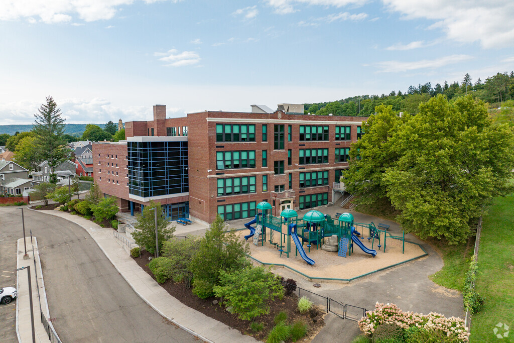 Woodrow Wilson Elementary School features a beautiful brick building with playground.