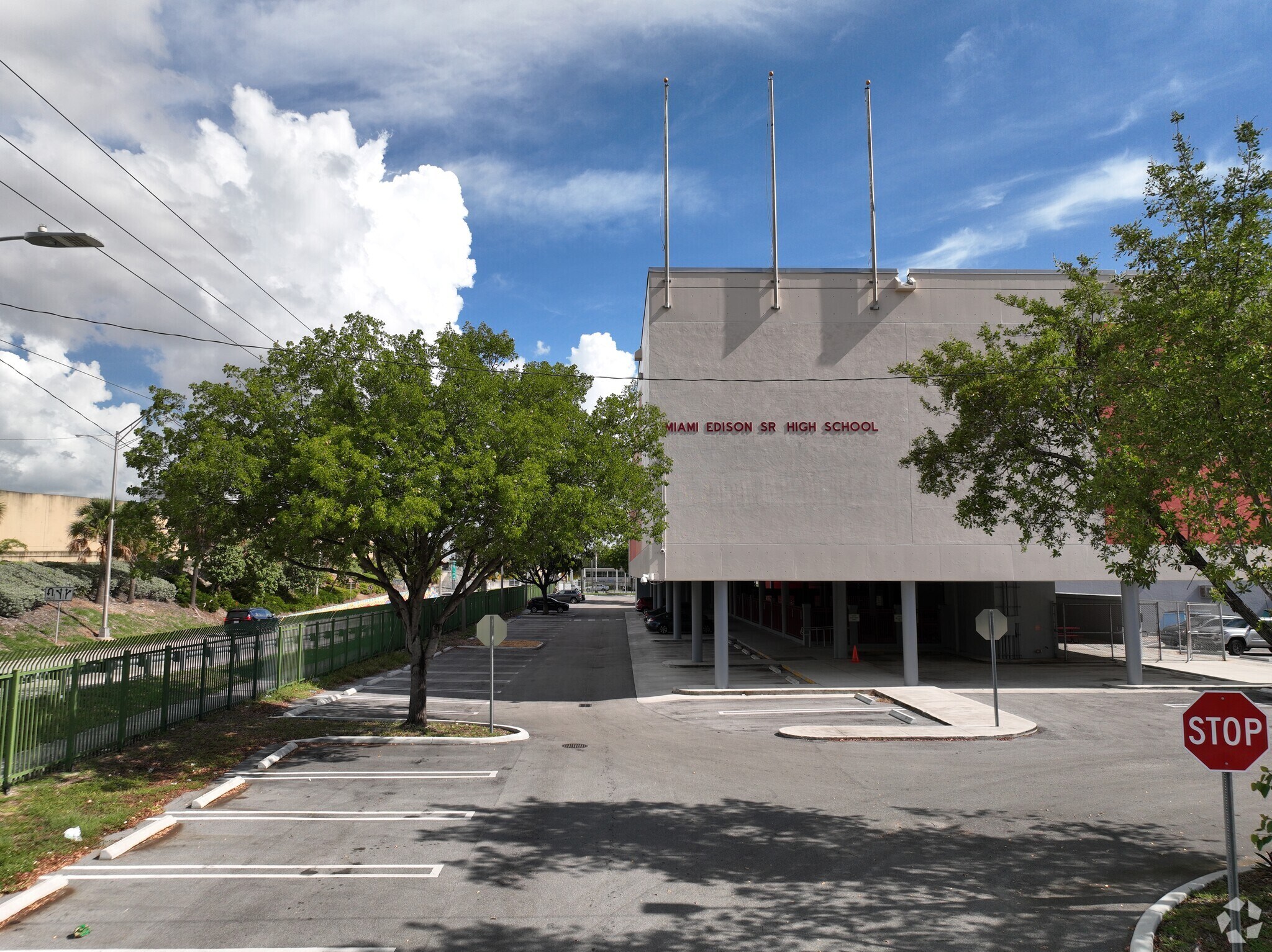 Back of the entrance at the school ground level with school name on building.