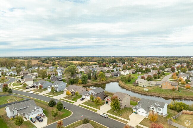 Mayer homes surround a serene pond, an example of Mayer’s tranquil suburban lifestyle.
