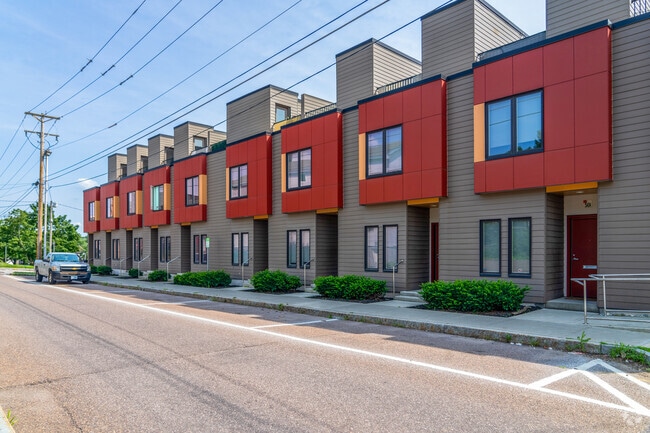 A condo complex in Downtown Winooski has a red and orange accents.