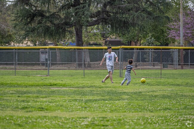 Father and son building a bond playing soccer at Lambert Park.