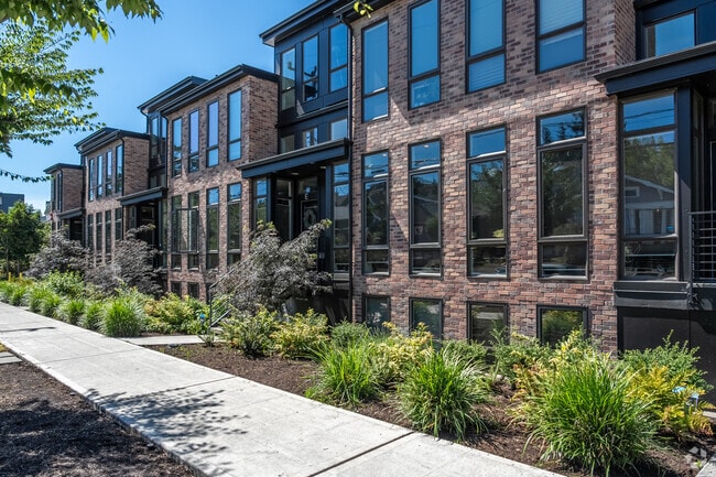 A row of brick townhomes on an Eastlake street.