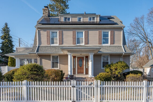 This beautiful Dutch Colonial Revival is located on Coligni Ave in Chauncey Estates.