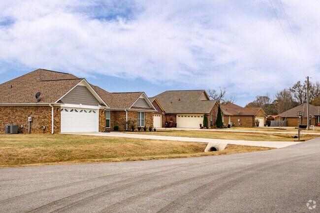 A row of beautiful brick ranch-style homes with attached garages in Cartwright.