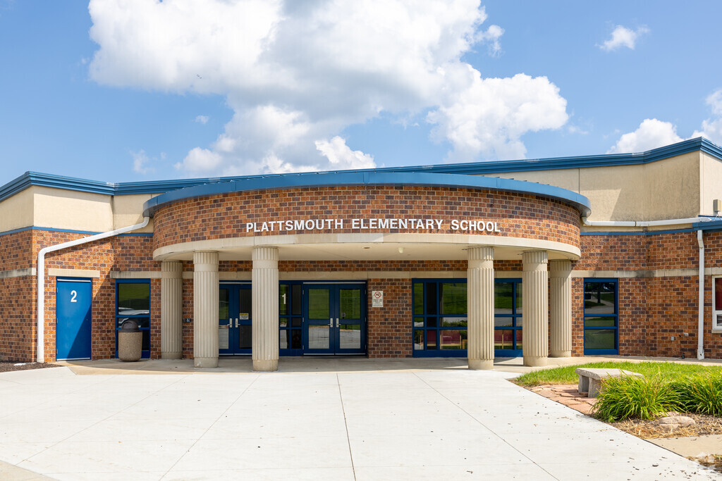 Plattsmouth Elementary school is surrounded by modern playground equipment for the students.