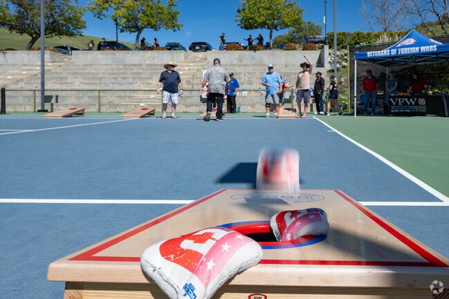 A toss makes the hole at the Clayton Cornhole Competition.