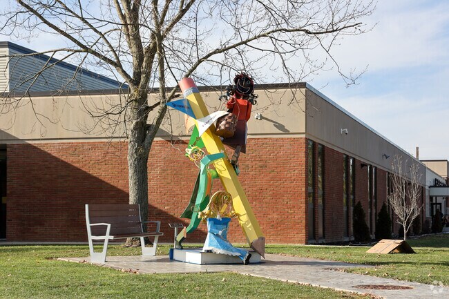 A cheerful sculpture welcomes students to Hillview Elementary School, in Grove City.