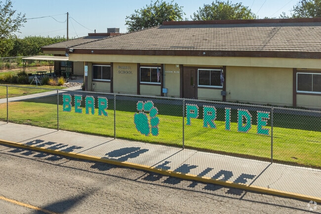 A large fence sign features the Burrel Elementary School mascot.