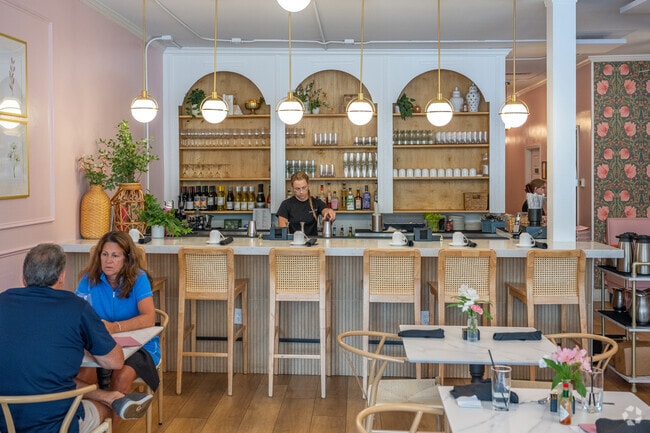 You can stop by for a refreshing drink at the vibrant bar during happy hour at Caroline's, located in the picturesque historic district of Flowers Crossing.