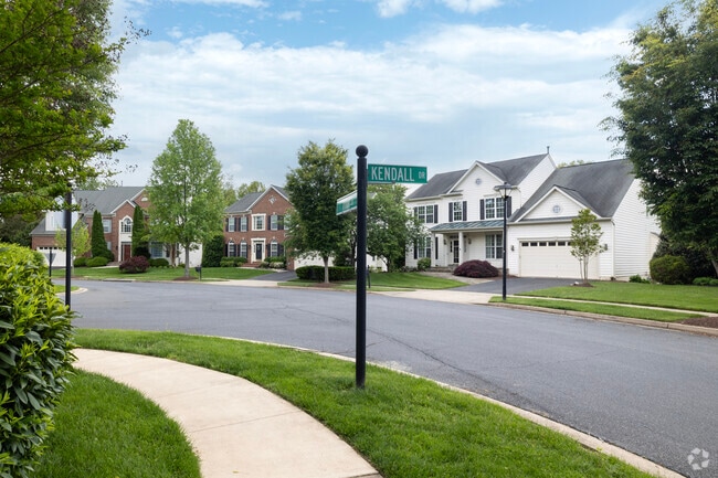Charming row of colonial homes with meticulous landscaping lines streets in Villages of Urbana.