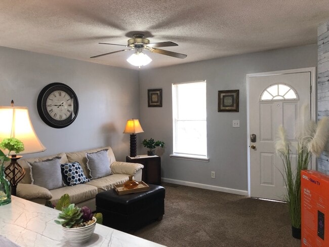 Comfortable living room with ceiling fan.