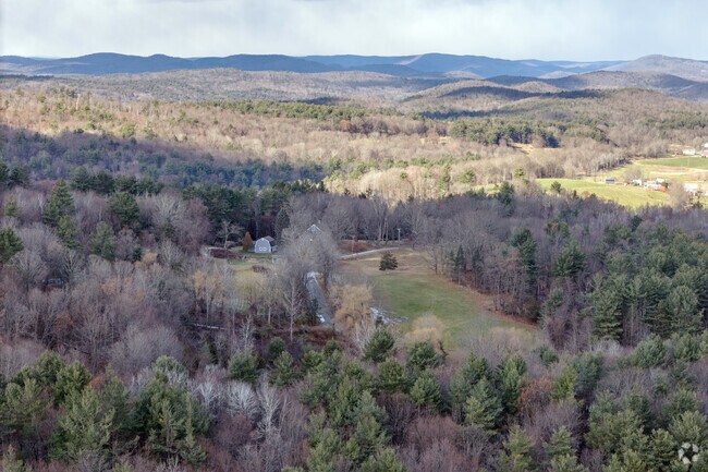 Looking across the valley that Conway occupies, dappled mountains stand in the distance.
