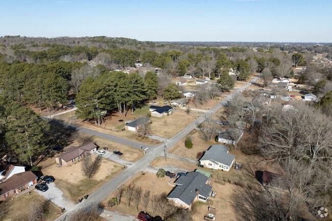 Flint City homes and mingled among a wooded landscape.