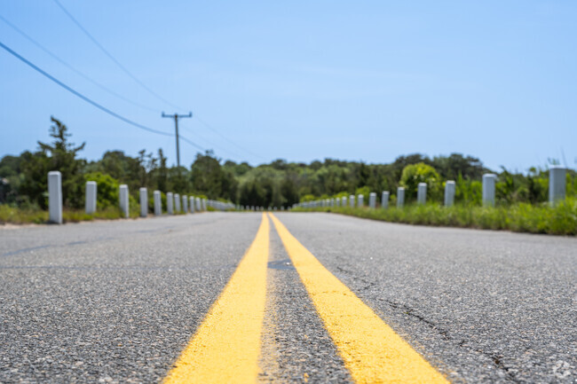 A narrow two-lane road leads to Monomoscoy Island.