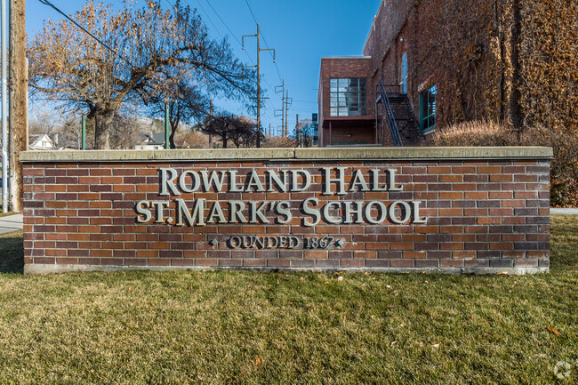 A traditional brick sign sits at the entrance of Rowland Hall.