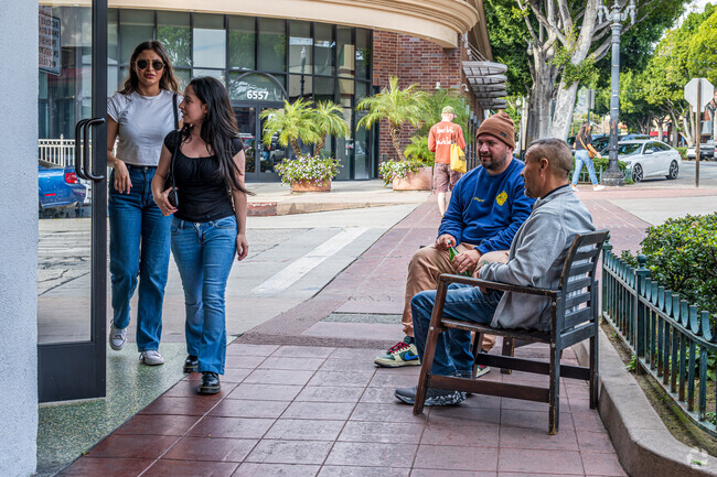 Two men enjoying coffee and a mild winter outside of Lift Coffee Roasters in Uptown Whittier.