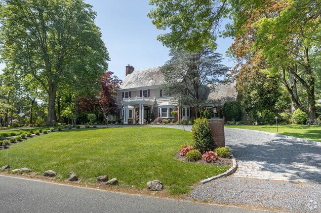 Grand residences in Hewlett Neck showcase architectural detail and manicured gardens.