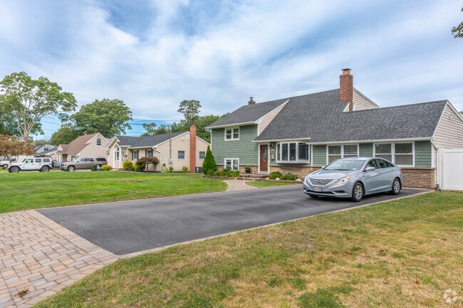 Raised ranch houses line residential blocks in Islip Terrace.