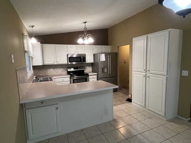 Kitchen with fridge, range, microwave and dishwasher