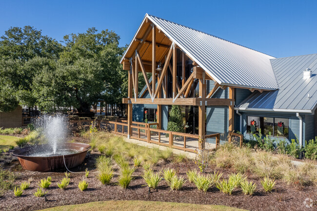 South Plains Food Company has an amazing atmosphere with outdoor seating under a large tree.