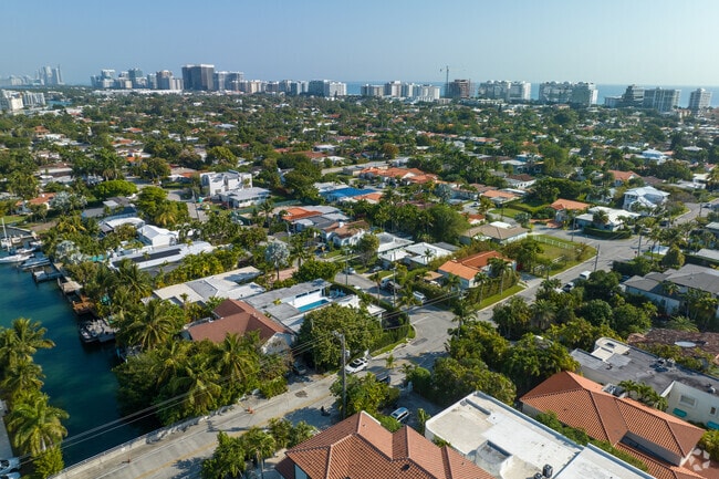 Aerial view of Surfside and beyond with ocean front high rises in the background.