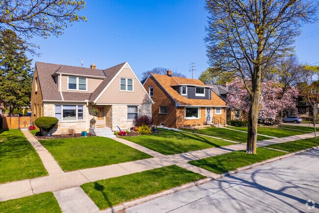 Single family homes sit on beautiful well maintained lawns in Riverwest located in Milwaukee.