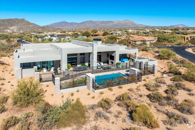 This custom Desert Mountain homes features a pool overlooking the desert sagebrush.