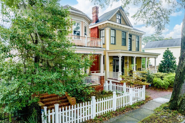 Homes in the neighborhood are often shaded by tall trees.