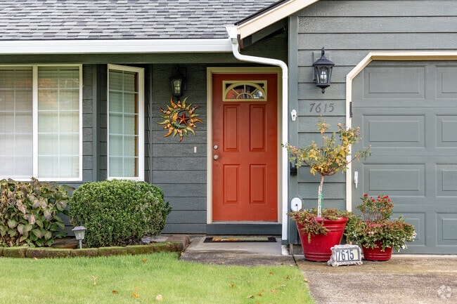 A muted orange door adds charm to a ranch home in Mountain View Meadows-Orchards.