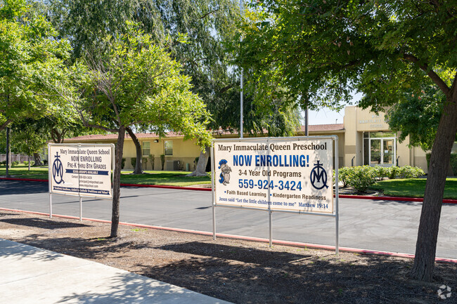Two banners are displayed at the entrance to Mary Immaculate Queen School in Lemoore.