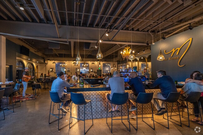 Inside Bar Roma, modern lighting and a sleek bar create a stylish Nob Hill vibe.