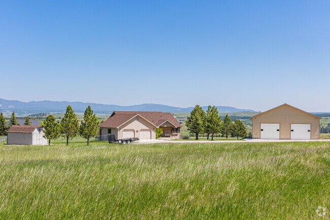 Some homes in Lewistown enjoy large plots of land with multiple structures like garages.