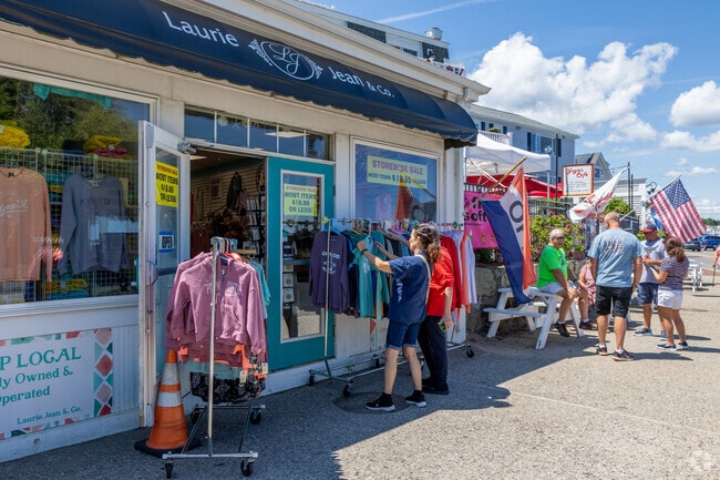 Tourists stop to pick out a souvenir whilst visiting the neighborhood of Plymouth Center.