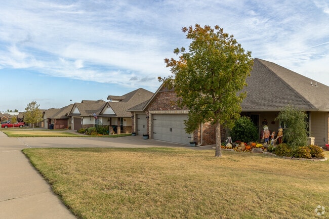 Row of brick and stone exterior homes with attached garages.