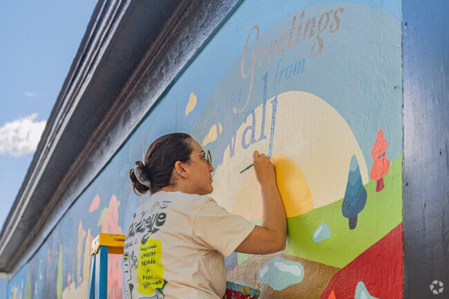 Ruby of Bullseye Mural Co. paints a mural of Walpole's historic landmarks and rural charm.