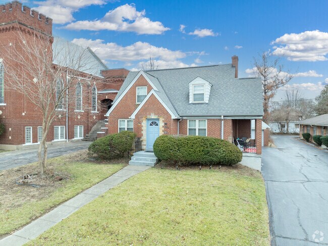 Many buildings surrounds various homes in this small town.