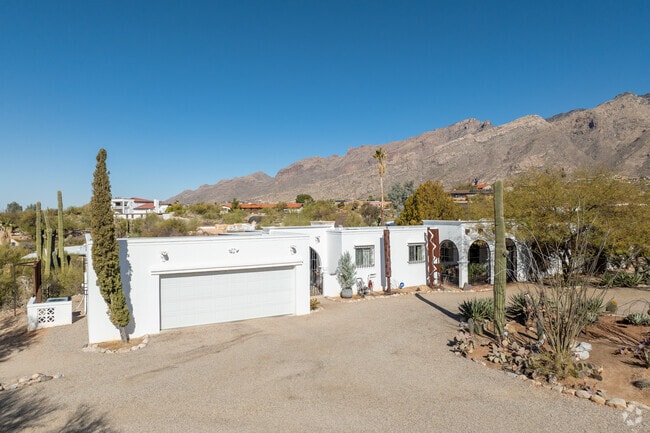 Spanish-Revival homes influenced by architect Josias Joesler in Catalina Foothills are set against a stunning backdrop.